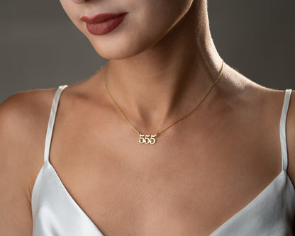 555 number necklace worn on model