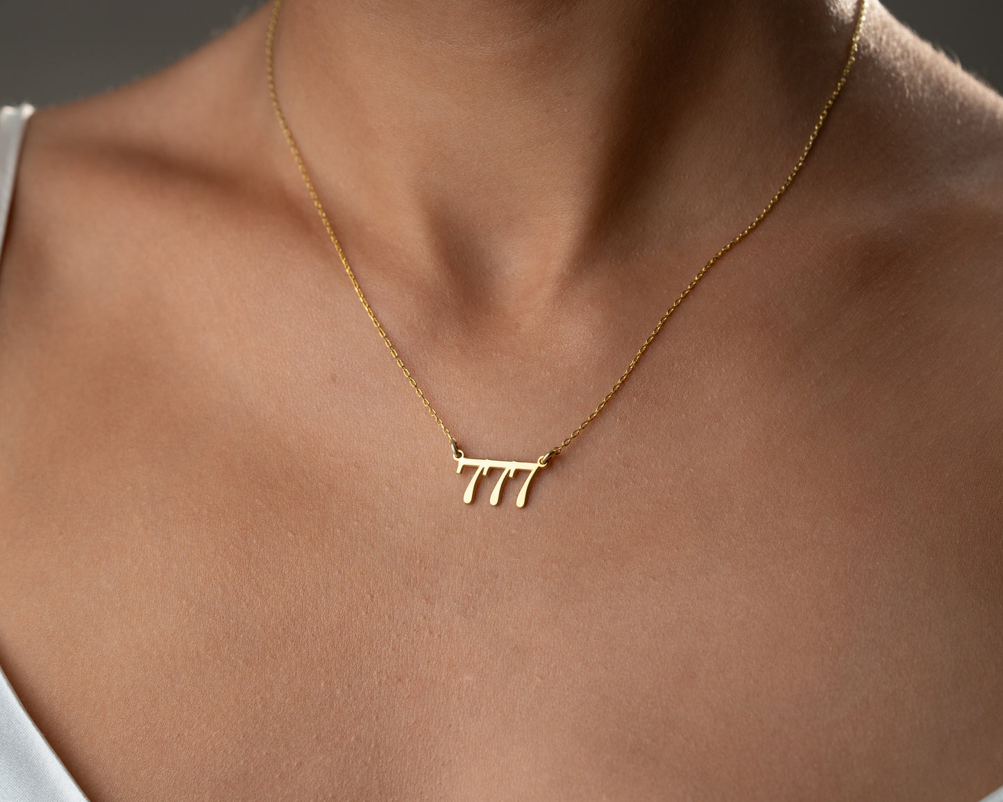 777 angel number necklace worn