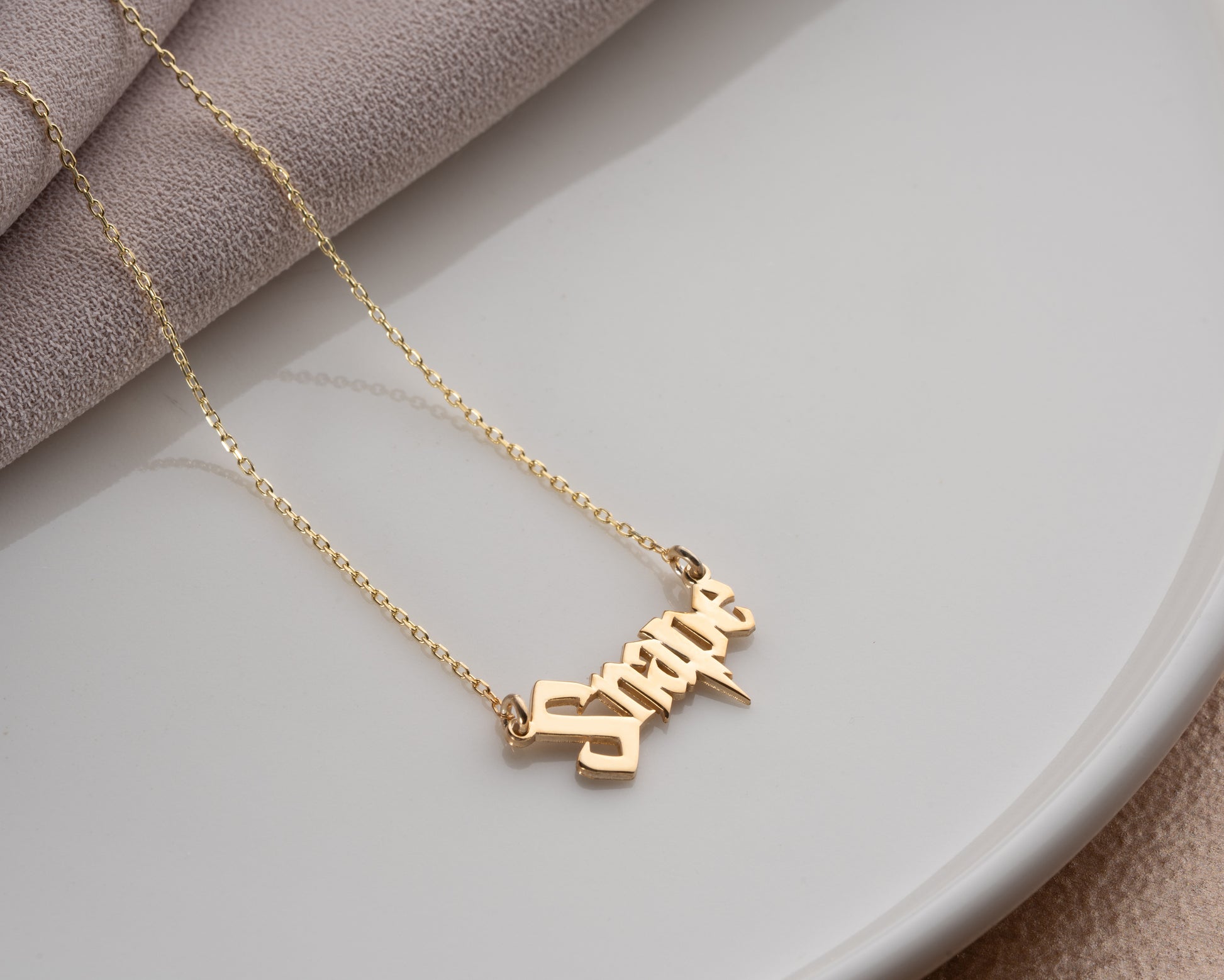 Fantasy script name necklace close-up