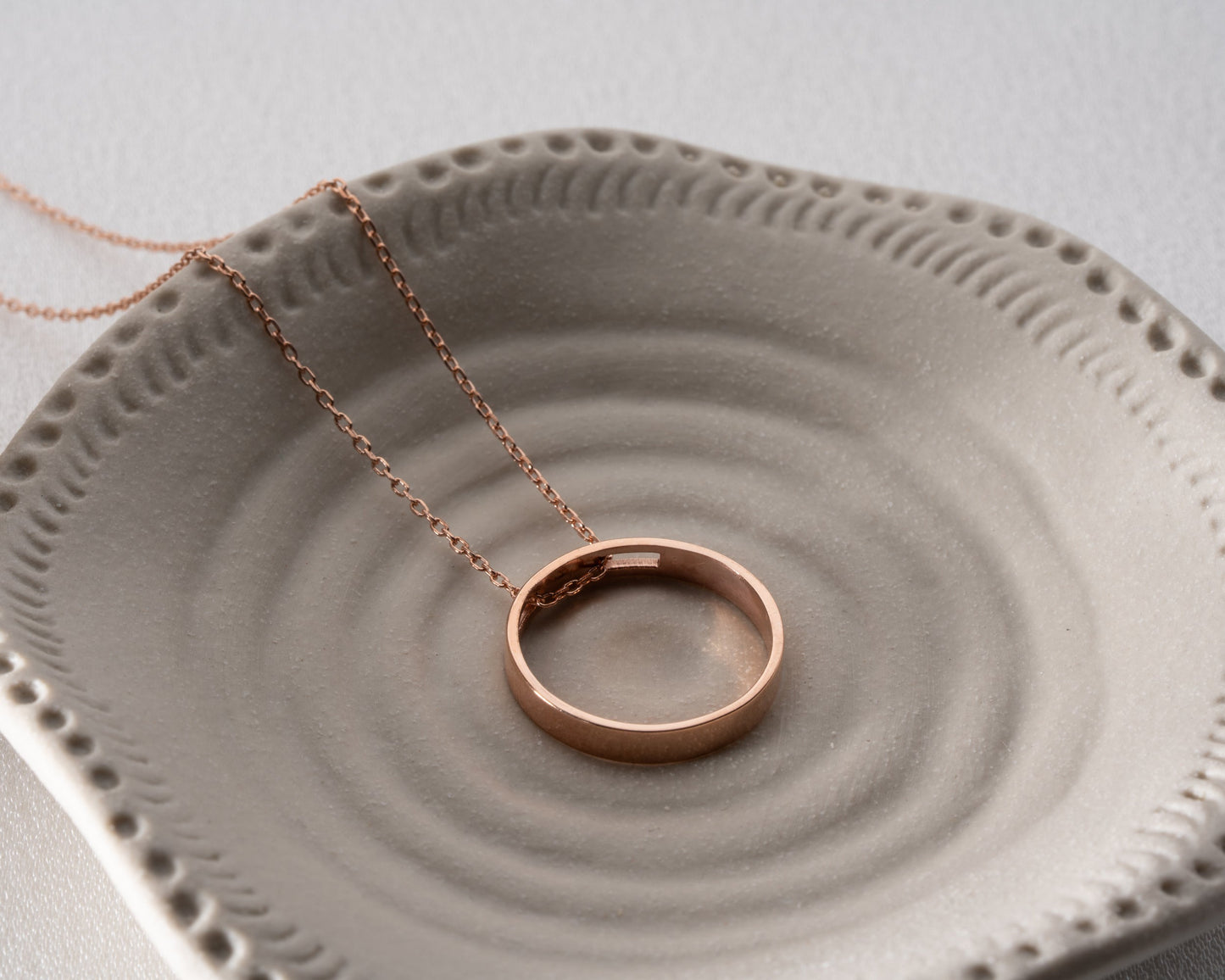 Engraved ring pendant necklace lifestyle detail