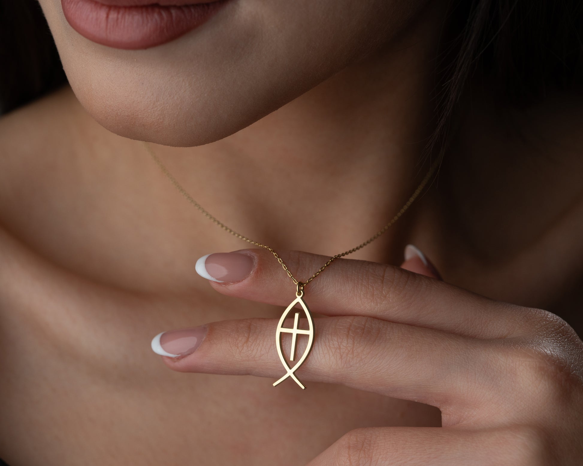 Fish cross necklace detail
