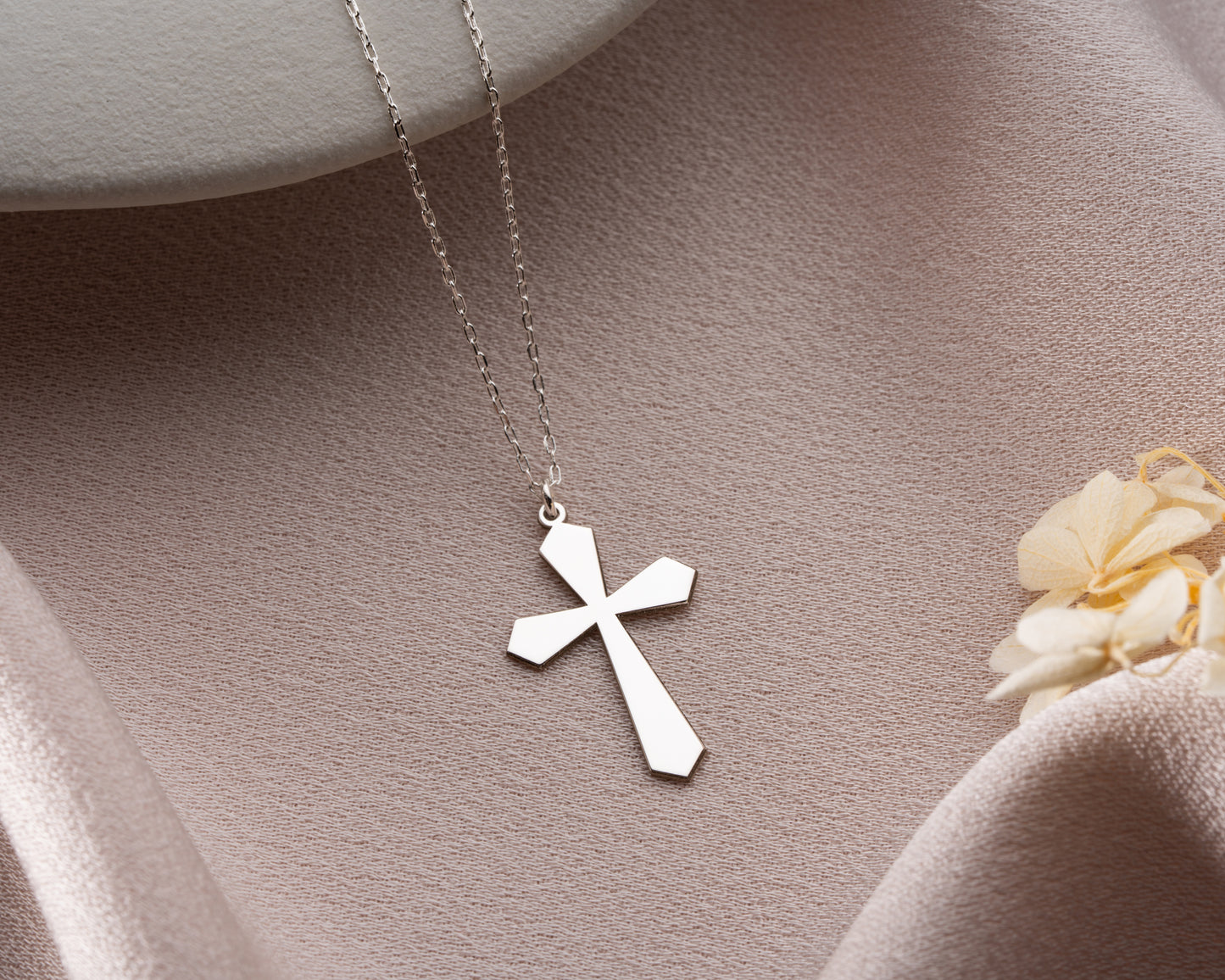 Flared cross necklace close up