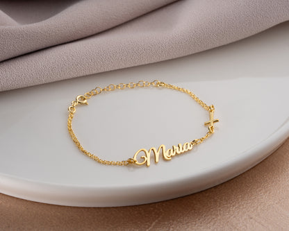 gold cross name bracelet display
