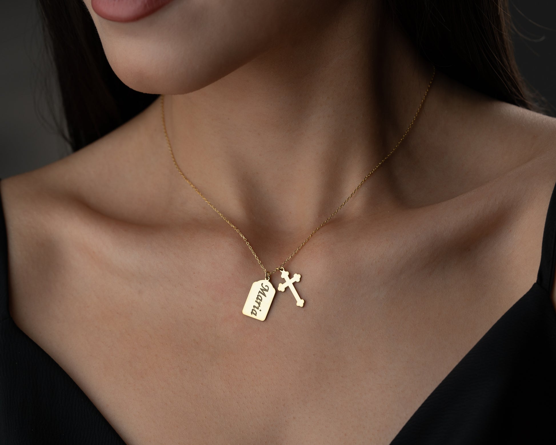 Gold personalized name cross necklace worn by model