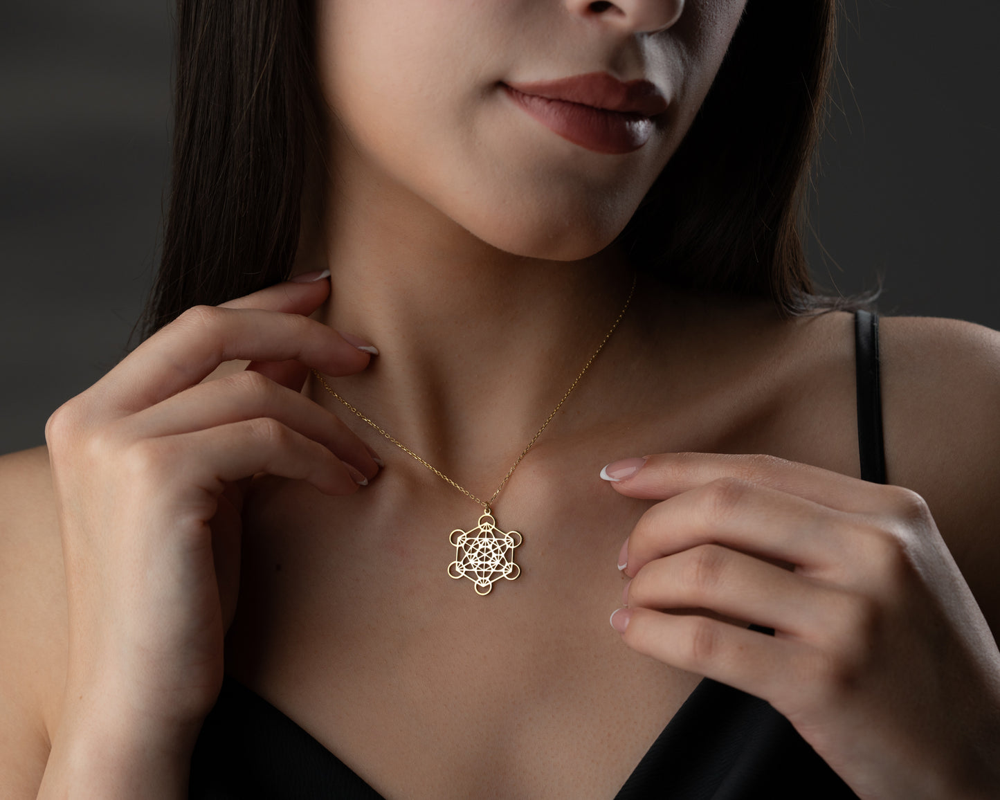 Gold sacred geometry necklace on model