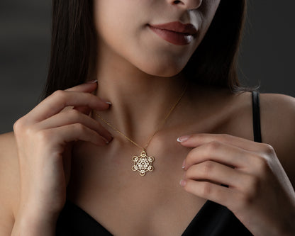 Gold sacred geometry necklace on model