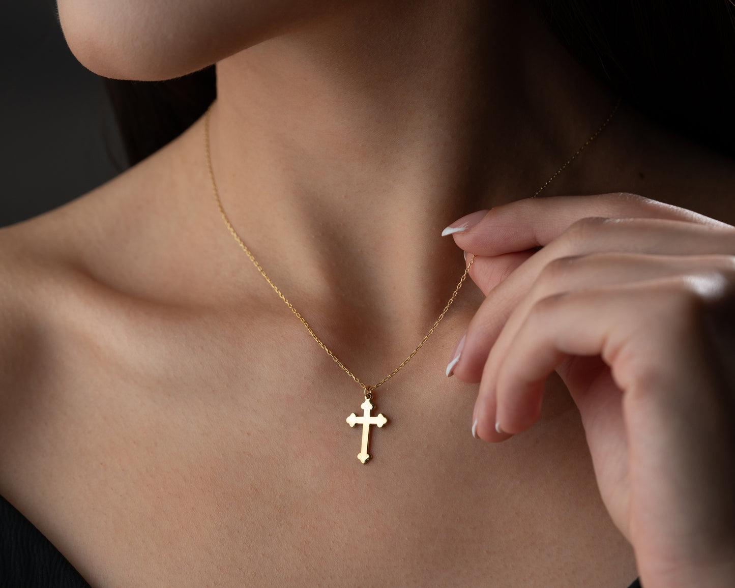 Gold trefoil cross necklace on model