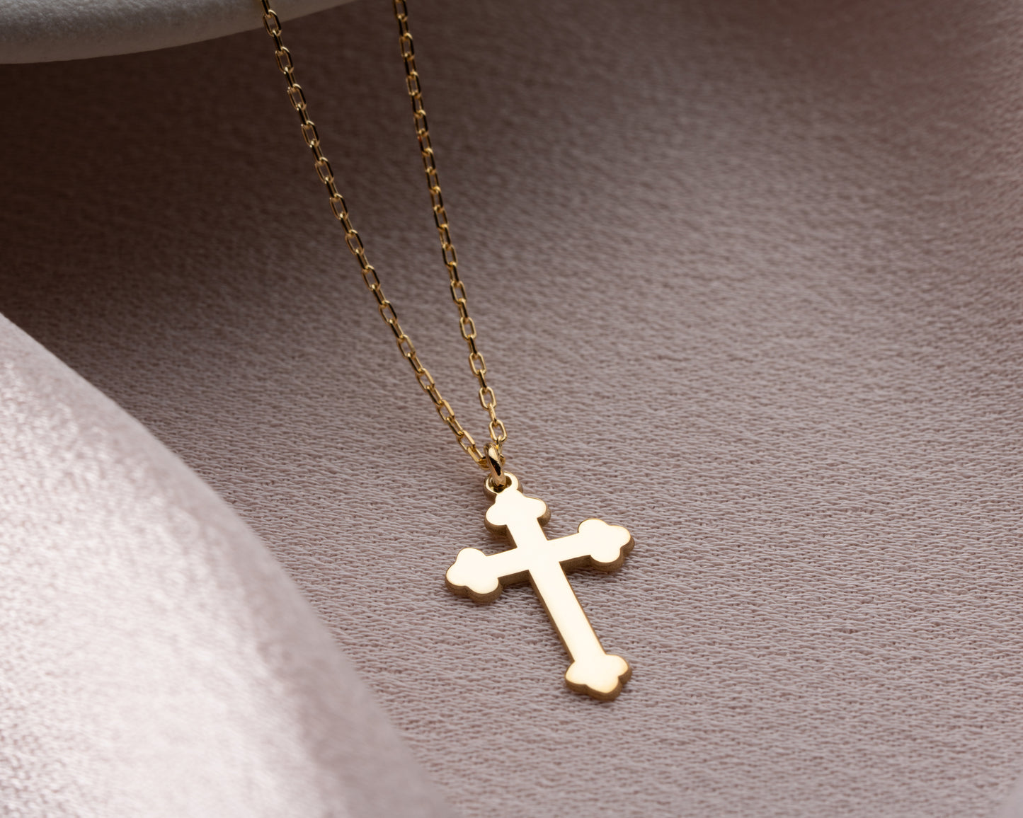 Gold trefoil cross pendant close-up