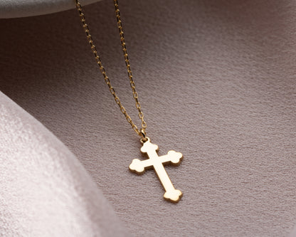 Gold trefoil cross pendant close-up