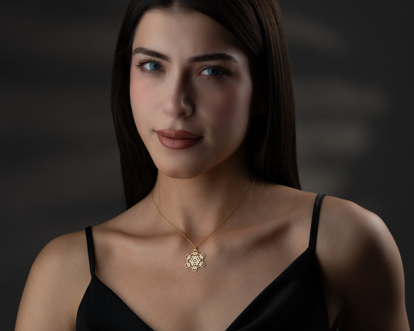 Gold Metatron's cube necklace on model