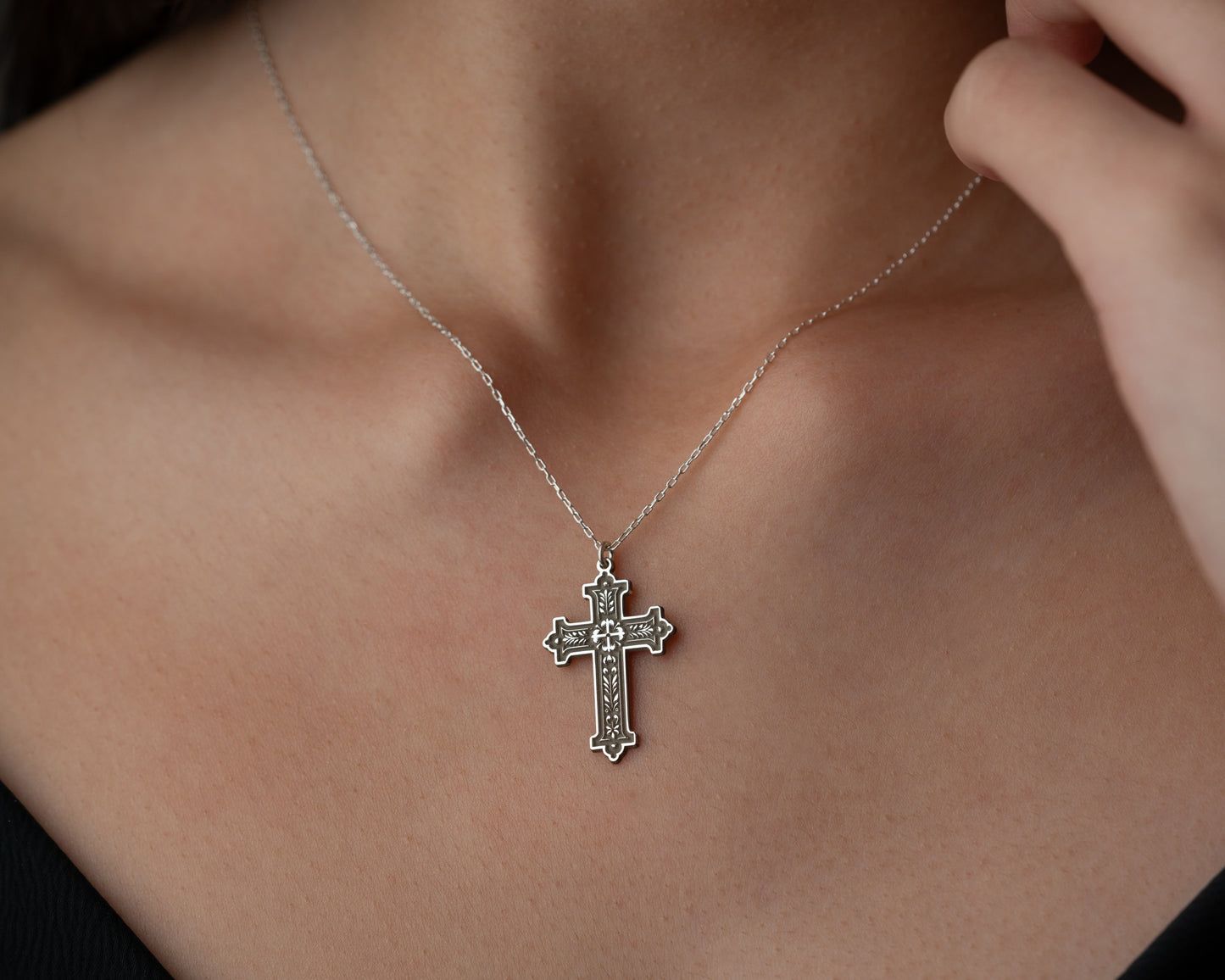 Ornate cross necklace detail