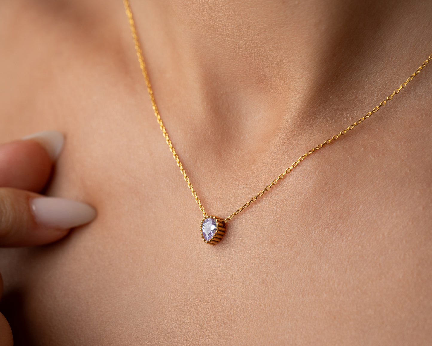 Pear birthstone necklace worn on model