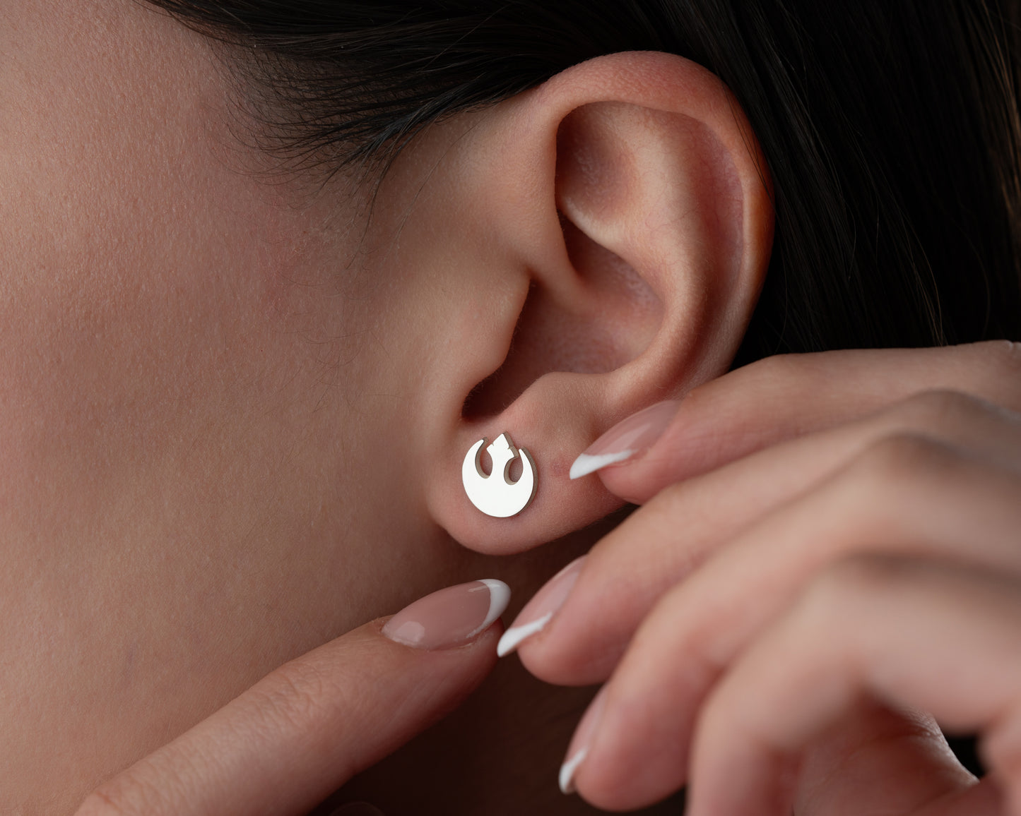 Gold rebel emblem earrings lifestyle view