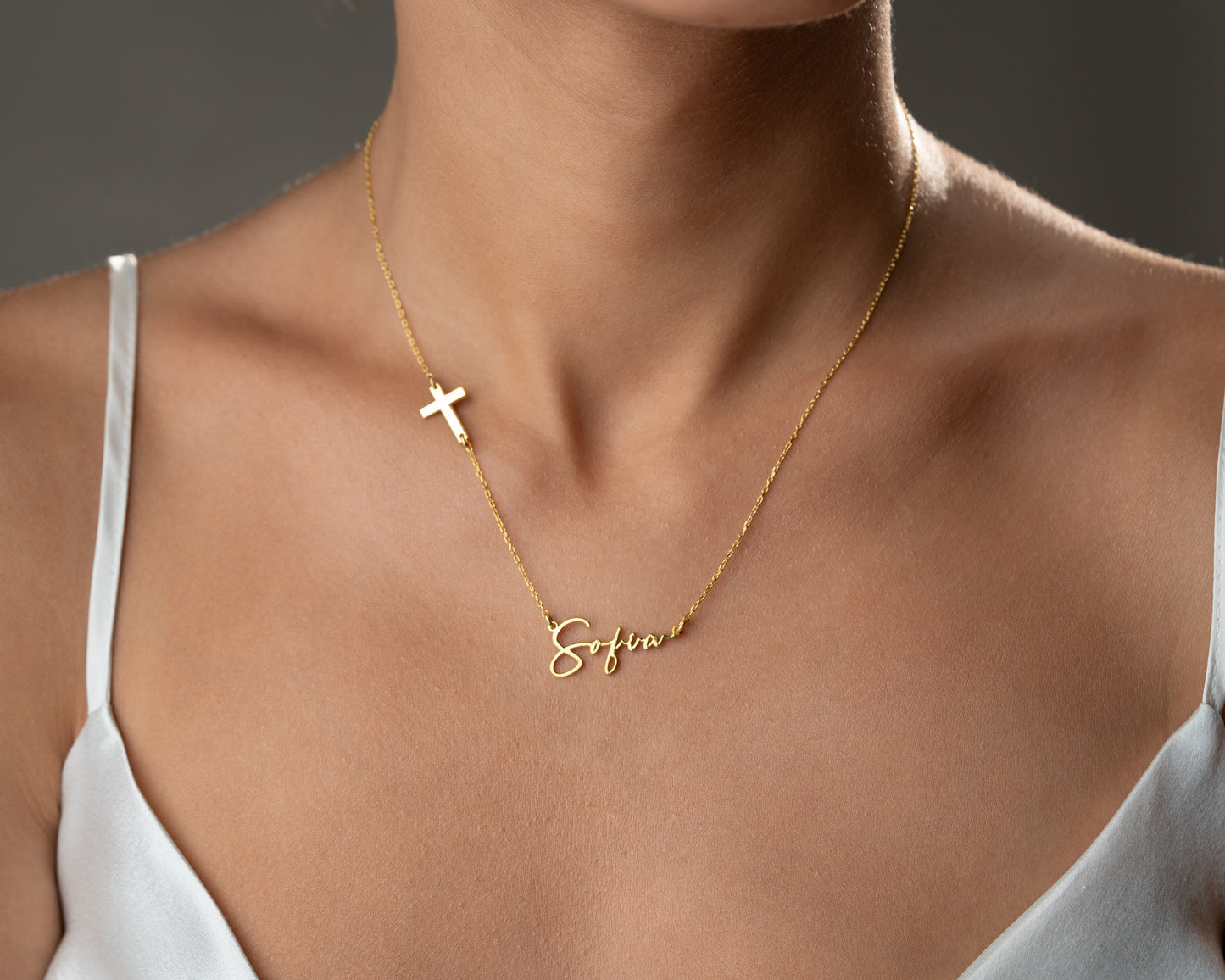 Script name and cross necklace worn