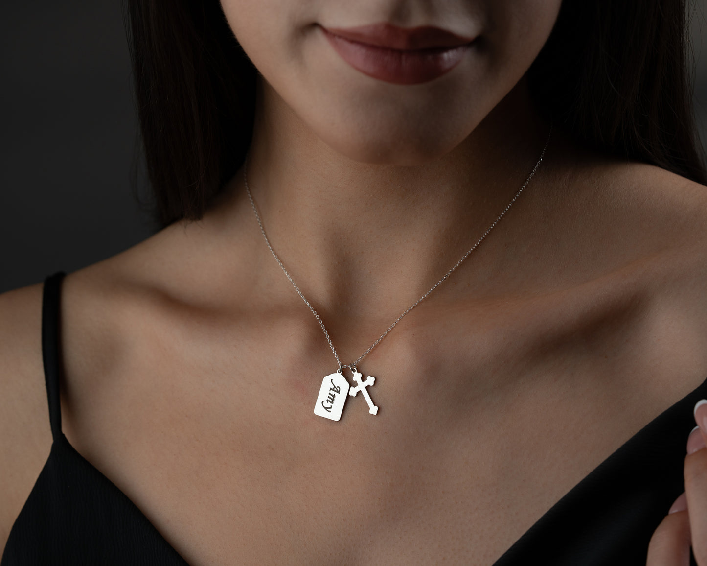 Silver personalized name cross necklace worn by model