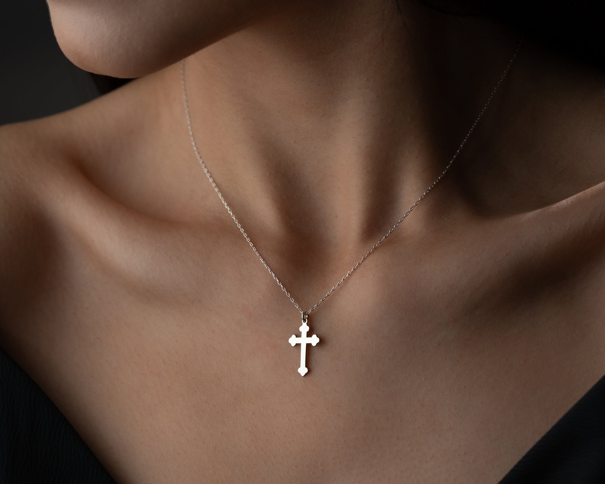 Silver trefoil cross necklace on model